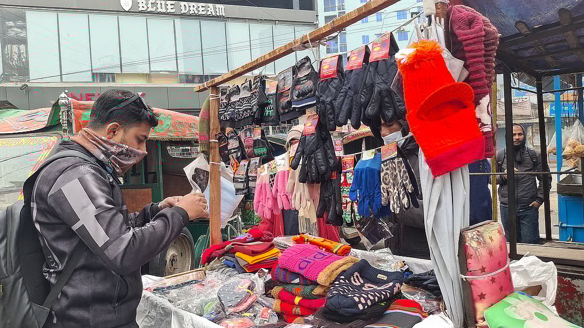 Rajshahi recorded the season’s lowest temperature at 8.4 degree Celsius.  A customer is seen at a winter socks and hats shop in the city's Kumarpara area around 10 am on 31 December, 2025.