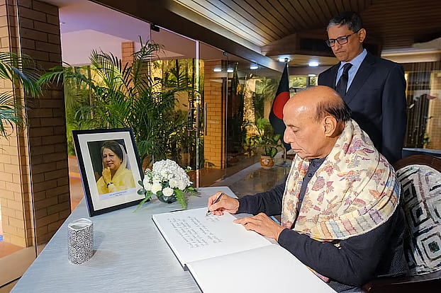 Indian Defence Minister Rajnath Singh writes in the condolence book for former prime minister Khaleda Zia at the Bangladesh High Commission in New Delhi.