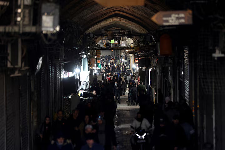 People walk past closed shops, following protests over a plunge in the currency's value, in the Tehran Grand Bazaar in Tehran, Iran, 30 December, 2025.