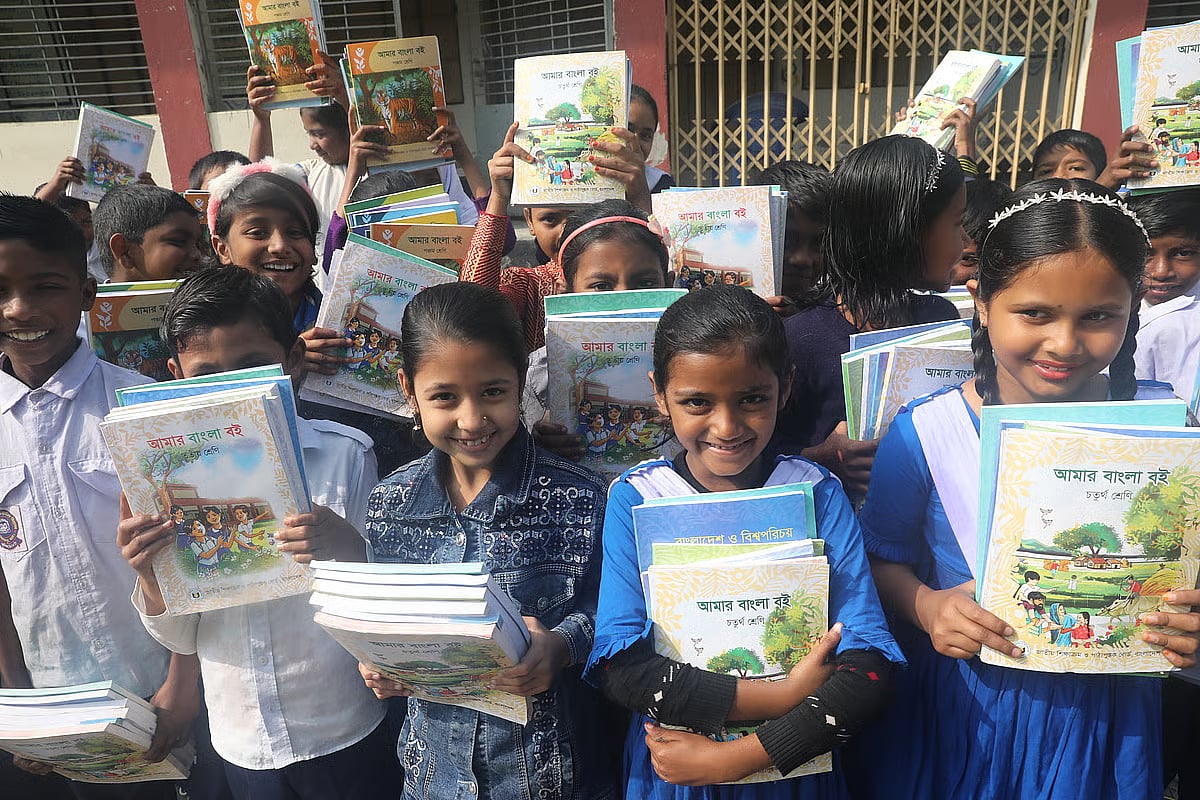 Students hold the new books provided from their school. Photo taken at Shah Nagar Government Primary School in Shajahanpur, Bogura on 1 January 2026.