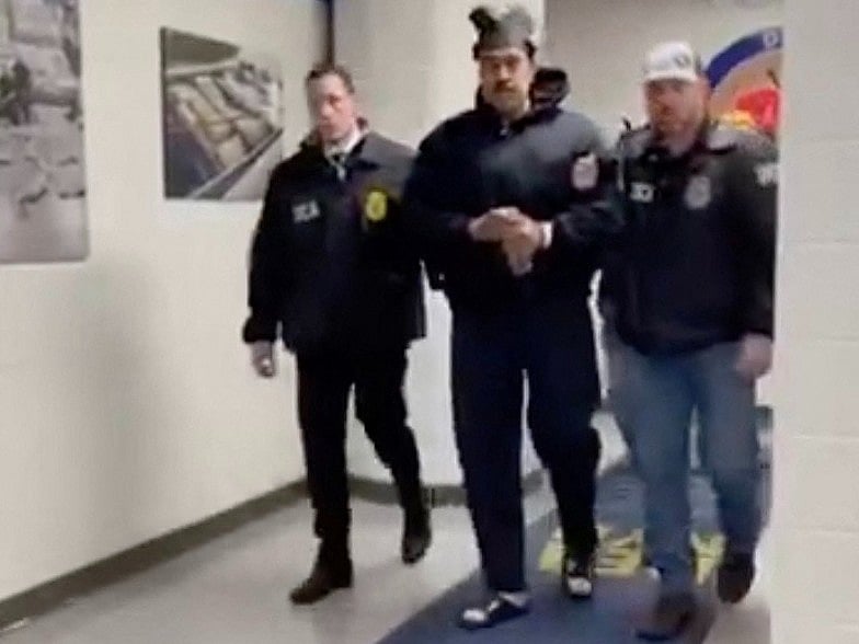 This screengrab taken from the X account of Rapid Response 47, the official White House rapid response account, shows Venezuelan President Nicolas Maduro (C) escorted by DEA agents inside the headquarters of the US Drug Enforcement Administration (DEA) in lower Manhattan, New York, on 3 January, 2026.