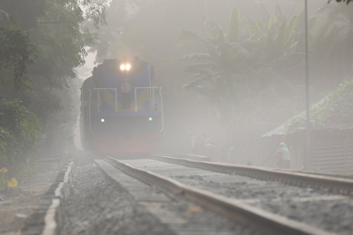 A morning train departs for its destination with its lights on amid dense fog. Mujgunni, Khulna, 4 January.