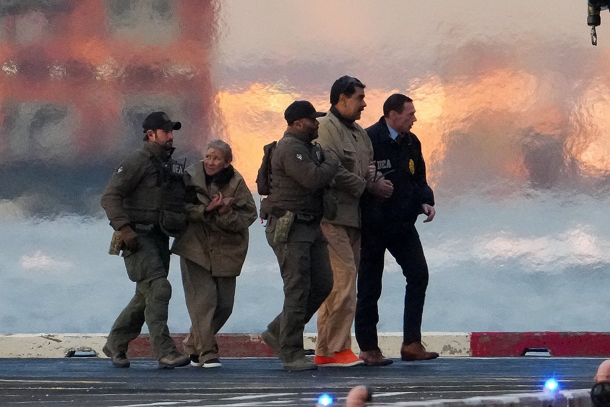 Law enforcement officials move captured Venezuelan President Nicolas Maduro and his wife Cilia Flores out of the helicopter, as Maduro heads towards the Daniel Patrick Manhattan United States Courthouse for an initial appearance to face US federal charges including narco-terrorism, conspiracy, drug trafficking, money laundering and others in New York City, US, on 5 January 2026