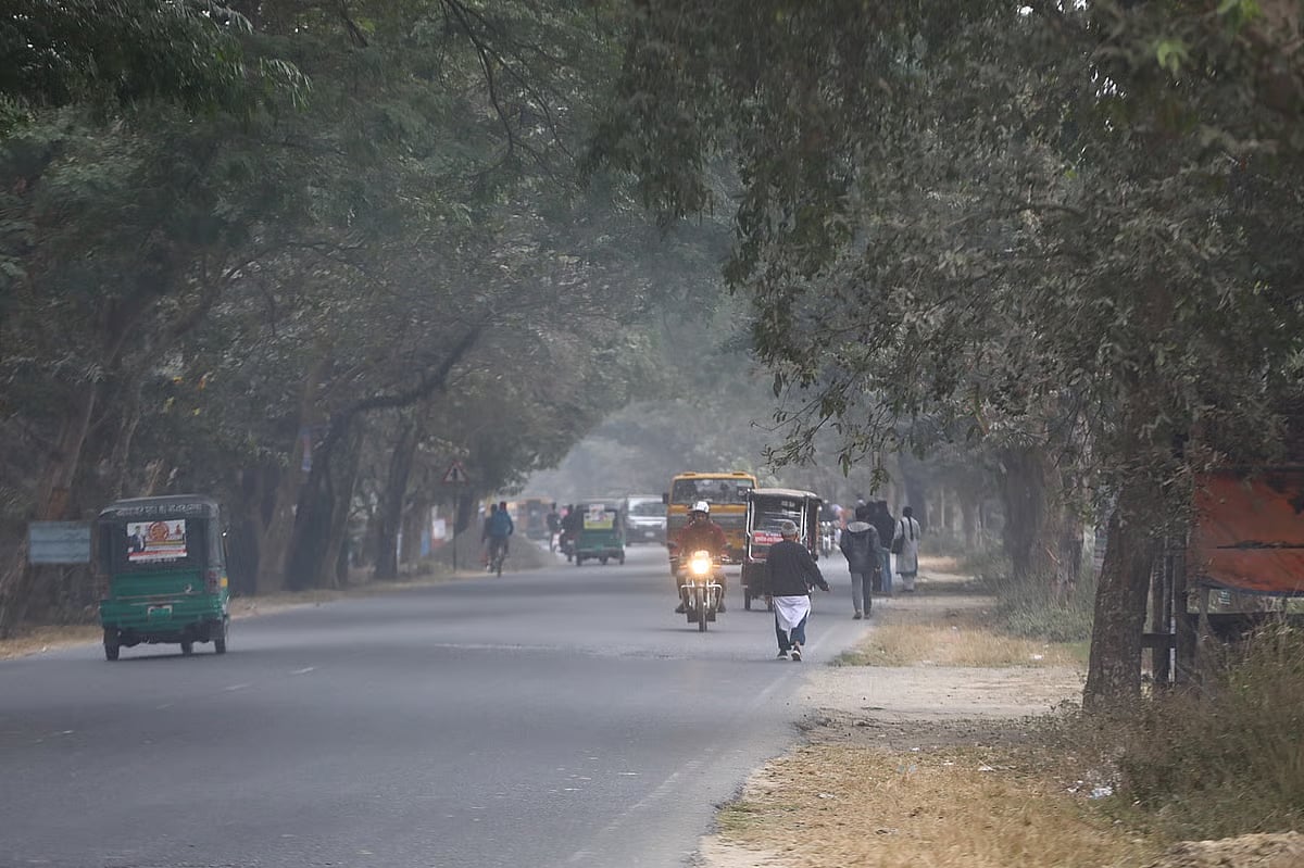 Sylhet-Tamabil highway covered in fog. A man driving his bike with his headlights on due to the fog. Khadimpara, Sylhet, 5 January 2025
