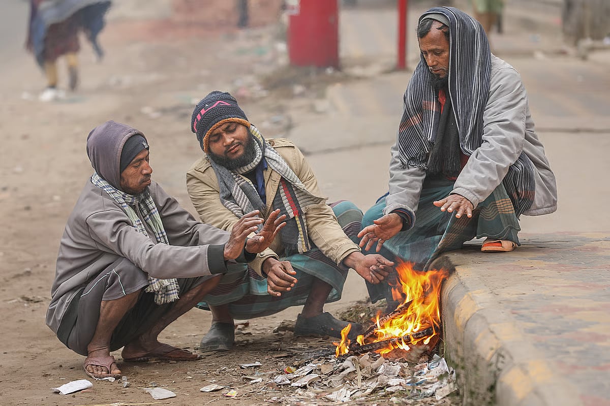 Three men are lighting fire in this cold weather to stay warm. Boyra, Khulna, 5 January, 2025.