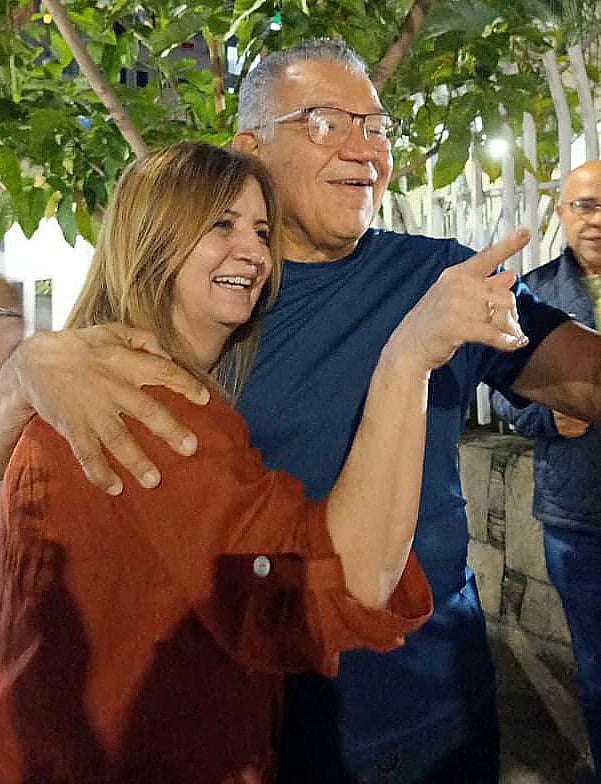 This courtesy handout picture released by the Marquez family shows former Venezuelan presidential candidate Enrique Marquez (R) embracing his wife, Sonia Lugo, after his release in Caracas on 8 January, 2026