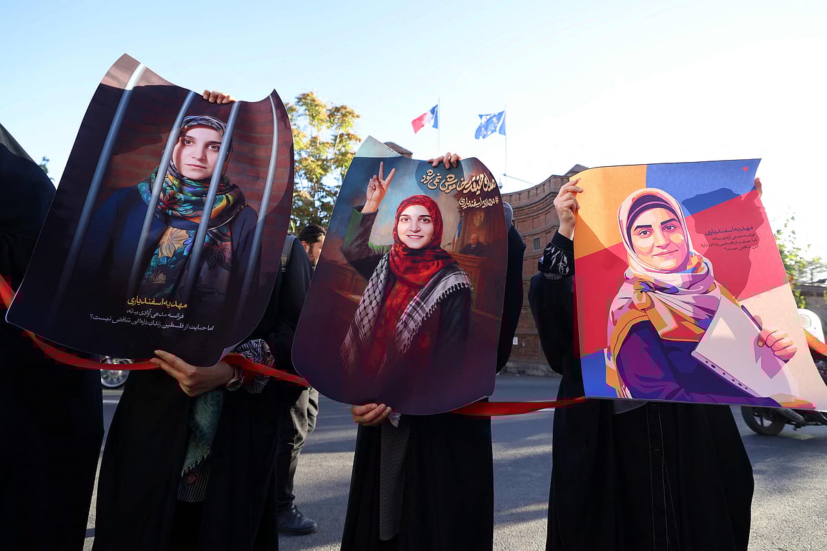 Protesters hold portraits of Mahdieh Esfandiari, an Iranian woman who was arrested in France in February during a rally calling for her release, outside the French embassy in Tehran on 21 October 2025. The trial of Mahdieh Esfandiari for condoning terrorism will begin in Paris on 13 January 2026. Esfandiari who was arrested in France on charges of promoting terrorism on social media, is wanted by Tehran in exchange for the release of Cécile Kohler and Jacques Paris.