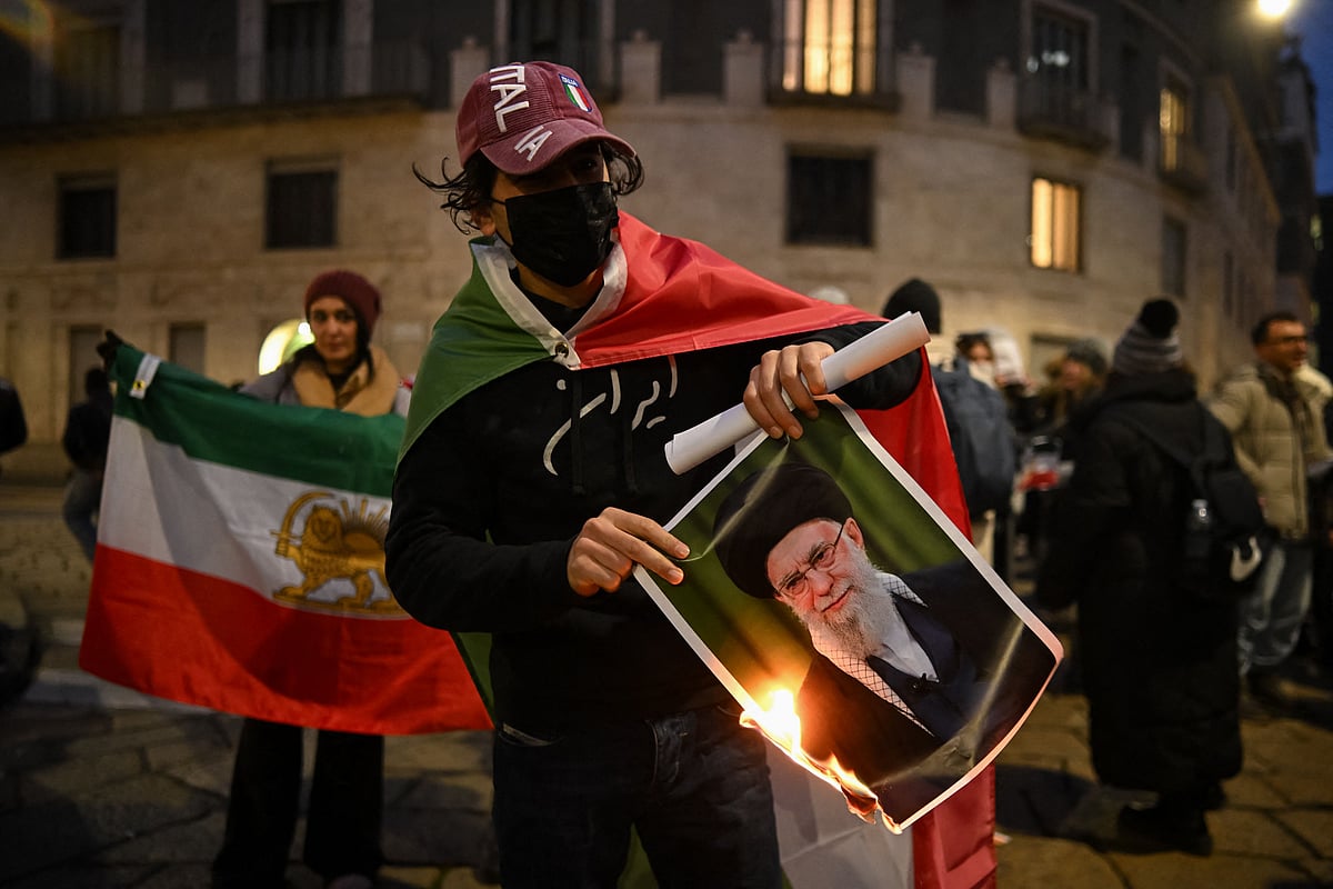An Anti-Iranian regime protester burns a photo depicting Ali Khamenei, Supreme Leader of Iran, during a gathering outside the US Consulate in Milan, on 13 January, 2026
