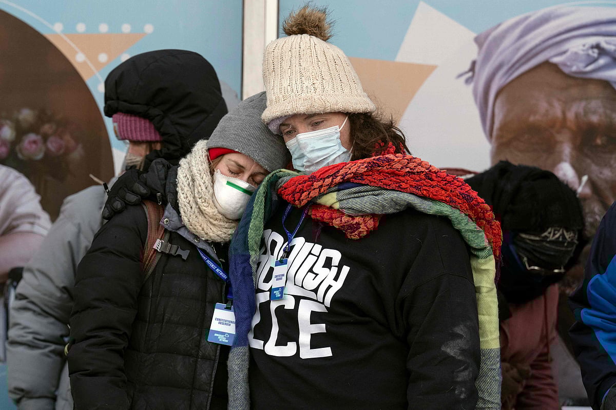 People mourn at a makeshift memorial in the area where 37-year-old Alex Pretti was shot dead by federal immigration agents earlier in the day in Minneapolis, Minnesota, on January 24, 2026