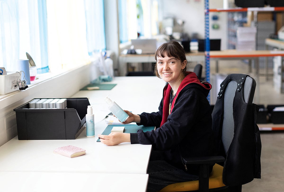 A woman works at a skincare company in Hove, Britain on 18 April 2023.