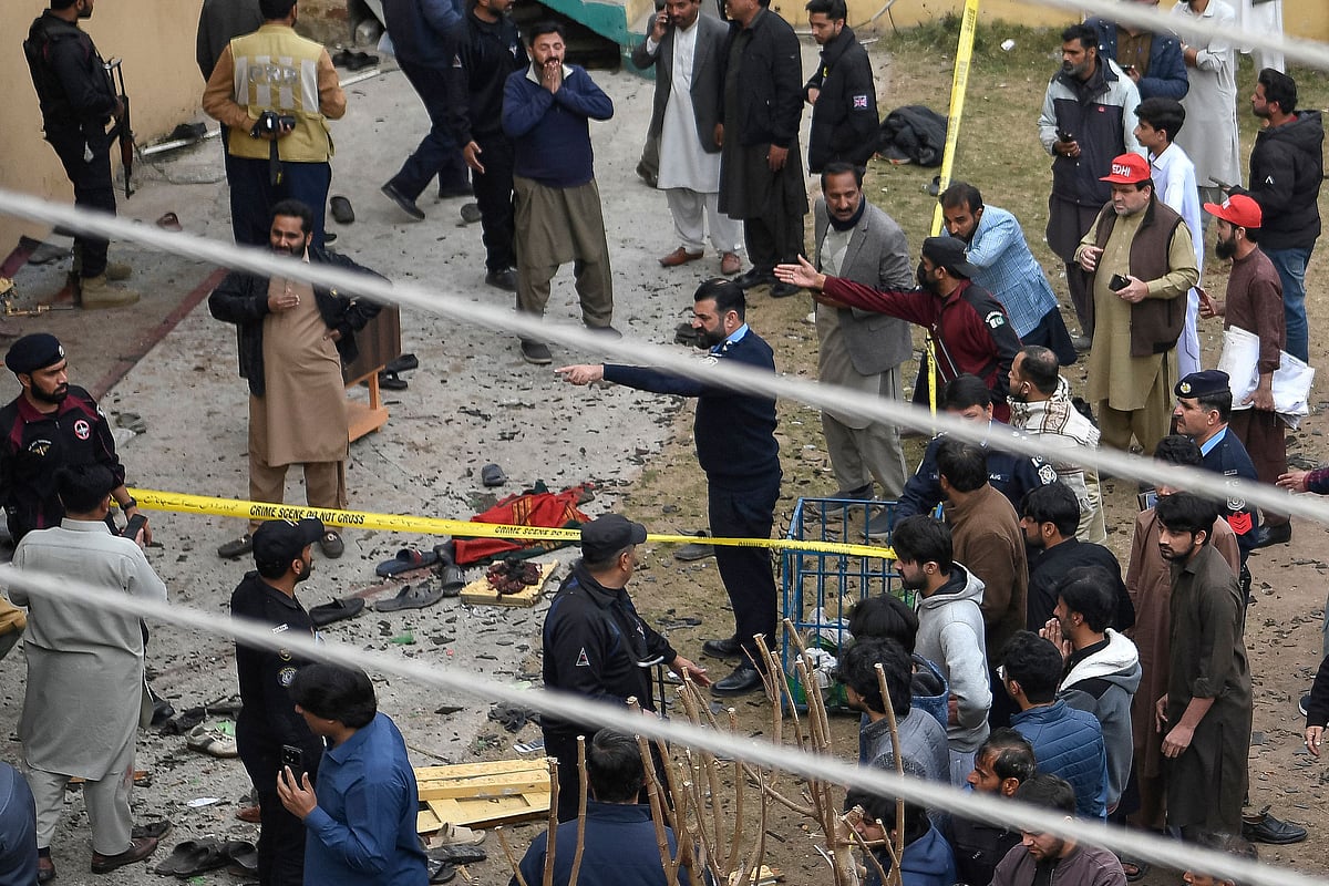 Security personnel and locals gather at a blast site inside a mosque in Islamabad on 6 February 2026.