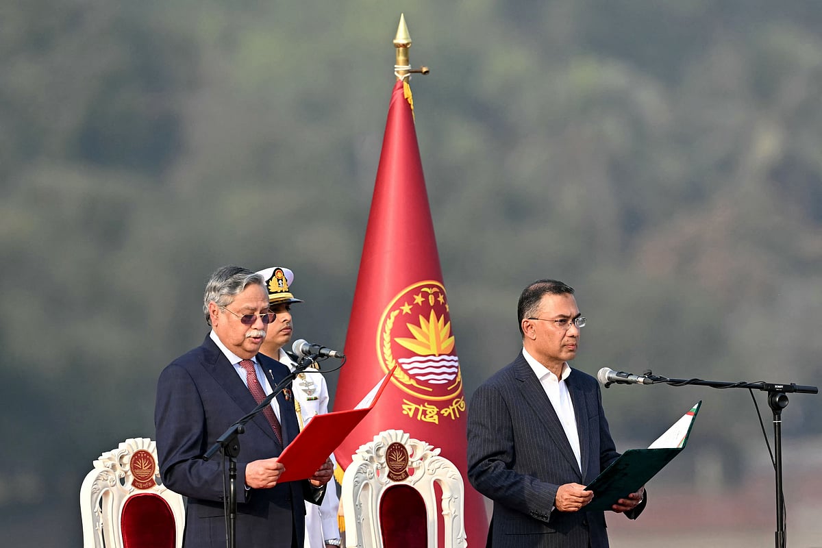 Bangladesh Nationalist Party (BNP) chairman Tarique Rahman (R) takes oath as prime minister during a swearing-in ceremony at the National Parliament building in Dhaka on 17 February 2026.