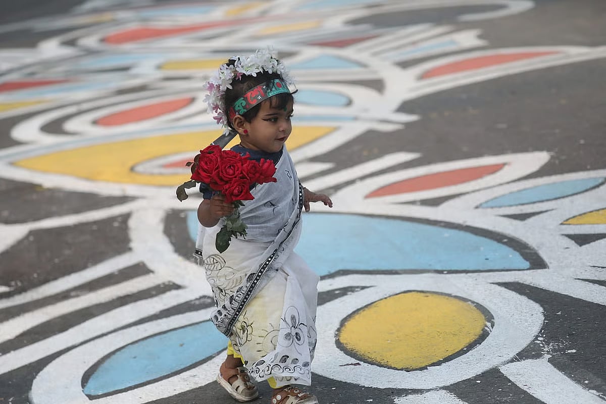 Carrying flowers, the child came to pay tribute to the Language Movement martyrs. Photo taken from the central Shaheed Minar in Dhaka on 21 February 2026.