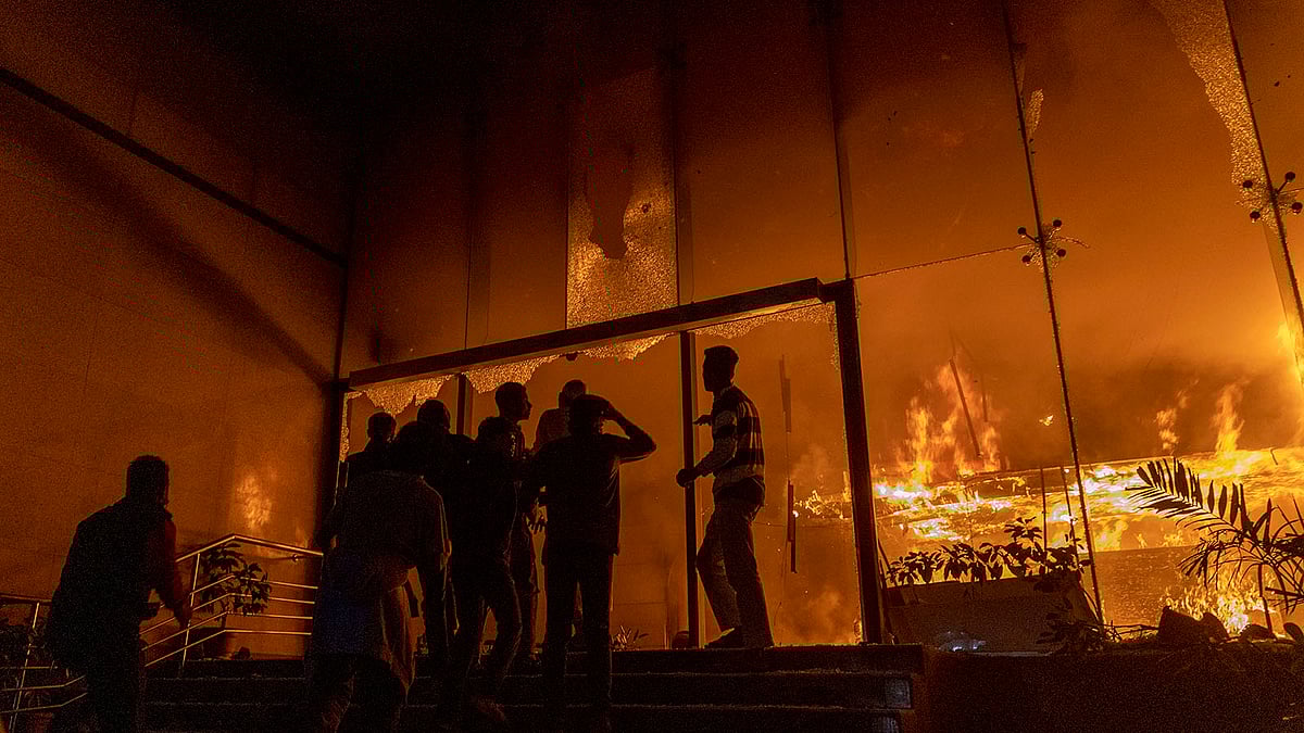 Mobs storm the burning building of The Daily Star on the night of December 18, 2025. 