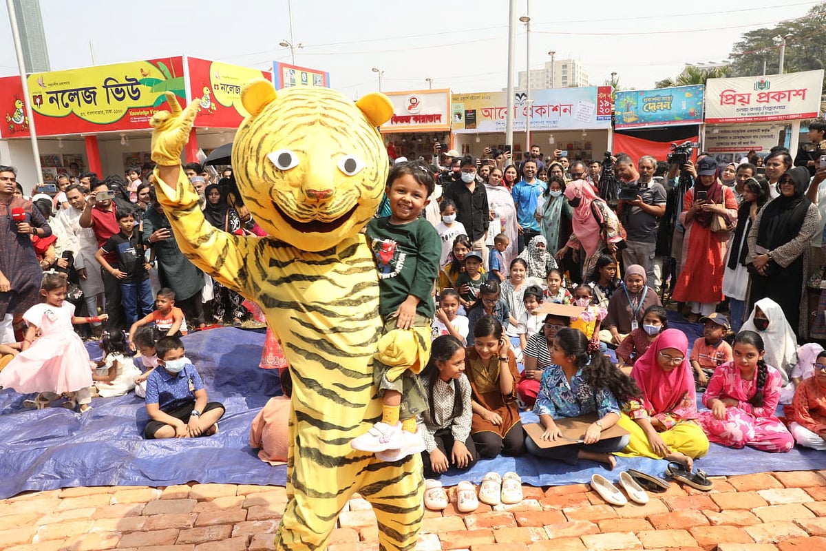 Dancing across the stage, the tiger puppet comes down among the children at the Amar Ekushey Book Fair in Suhrawardy Udyan in Dhaka on 27 February 2026.