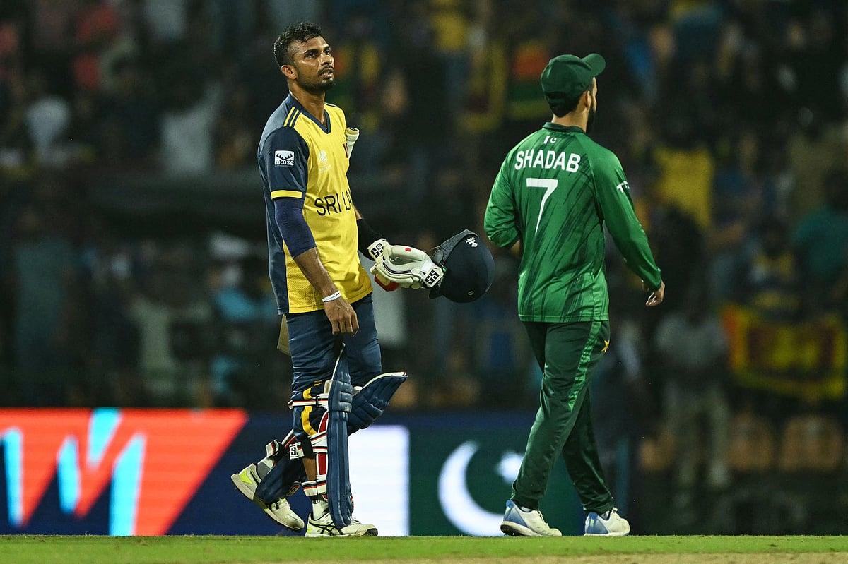 Sri Lanka's captain Dasun Shanaka (L) walks back to the pavilion after his team's loss against Pakistan at the end of their 2026 ICC Men's T20 Cricket World Cup Super Eights match in the Pallekele International Cricket Stadium, Kandy on February 28, 2026