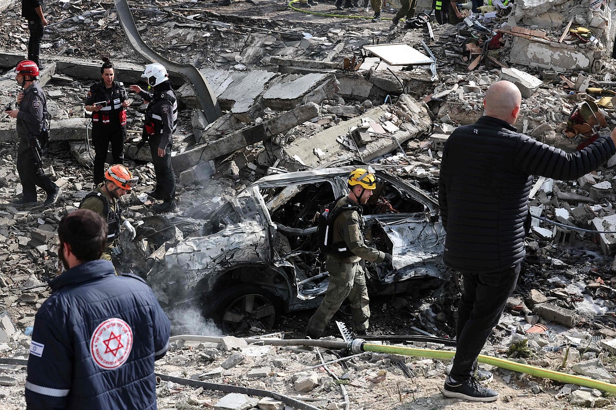 An Israeli emergency service officer walks past the debris of building at the scene of a missile attack near Bet Shemesh, some 30 kilometres west of Jerusalem on 1 March 2026. A barrage of missiles launched from Iran killed at least six people in the central Israel city of Bet Shemesh on 1 March Israel's first responders agency, Magen David Adom (MDA) said, the day after the US and Israel attacked Iran and assassinated its supreme leader.