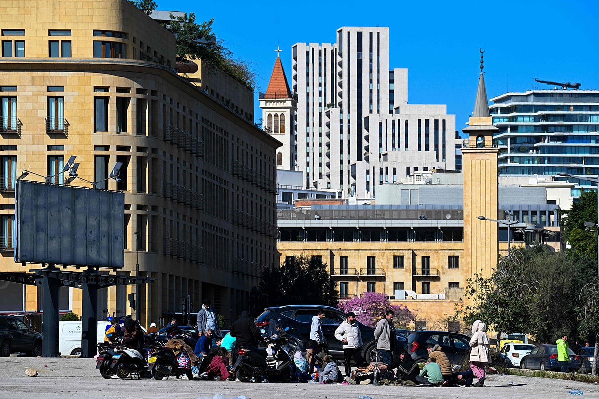 Families who fled their homes in Beiruts southern suburbs following Israeli strikes sit in a square in the city center on March 2, 2026. Israel bombarded Lebanon on March 2, expanding conflict across the region after the massive Israel-US attack on Iran that President Donald Trump launched to topple Tehran's ruling clerics.