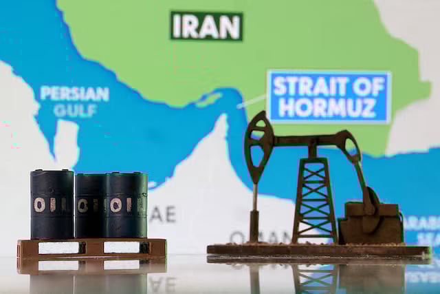 3D-printed oil barrels, an oil pump jack and a map showing the Strait of Hormuz and Iran appear in this illustration taken 2 March, 2026.