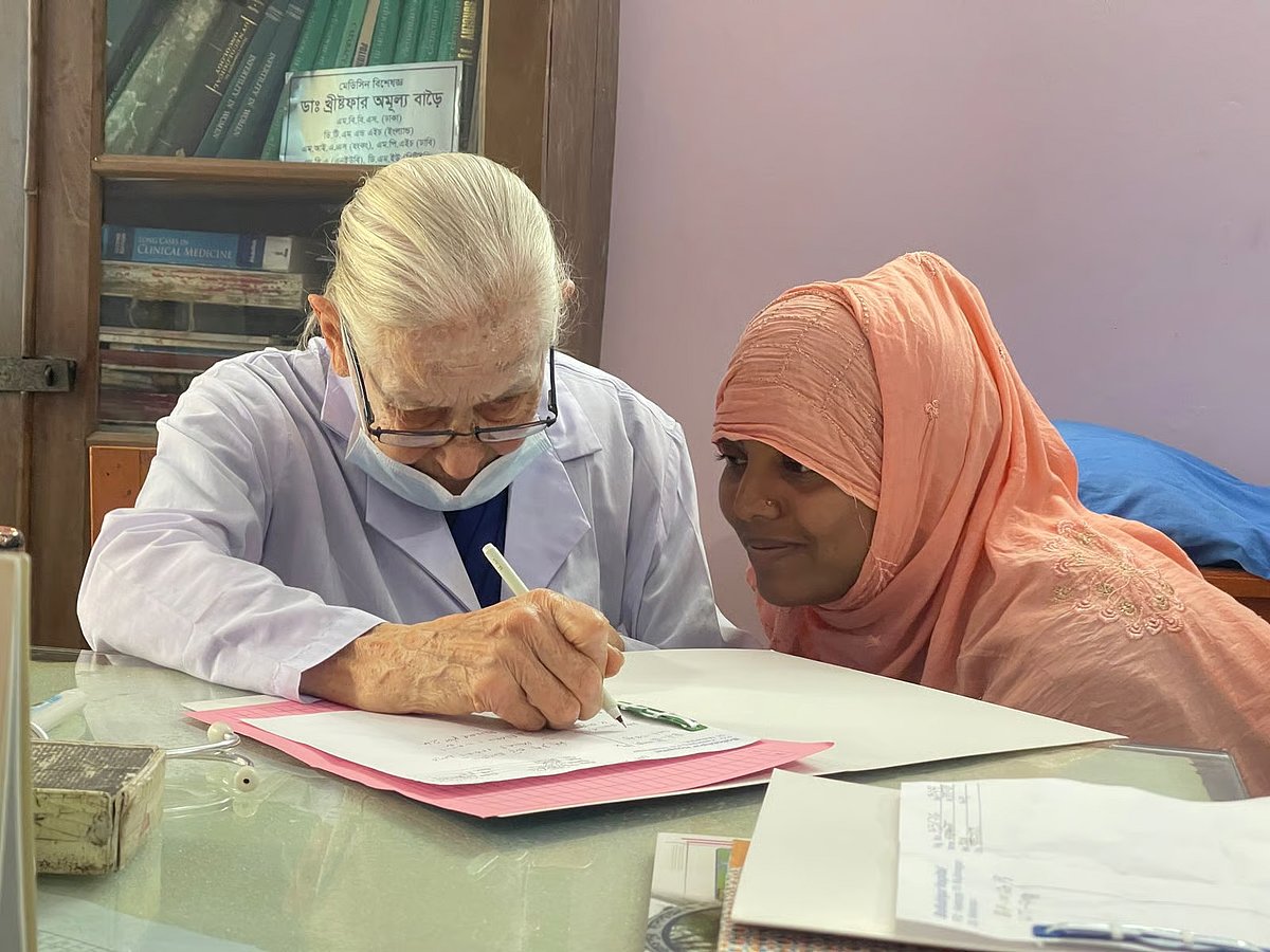 Jillian Margaret Rose, 87 years old, serves a patient at Bollovepur Hospital in Meherpur.