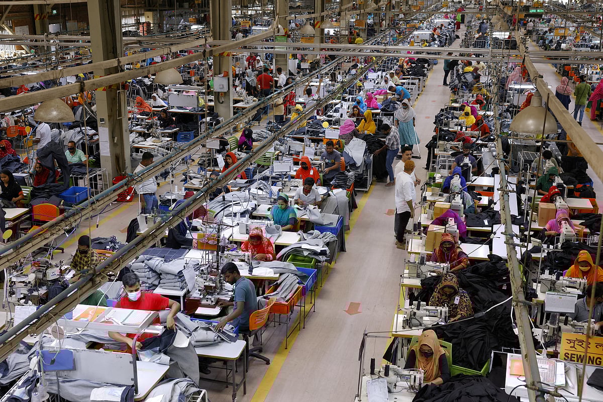Bangladeshi garment workers make clothing in the sewing section of a factory in Gazipur, Bangladesh, 9 April 2025. 