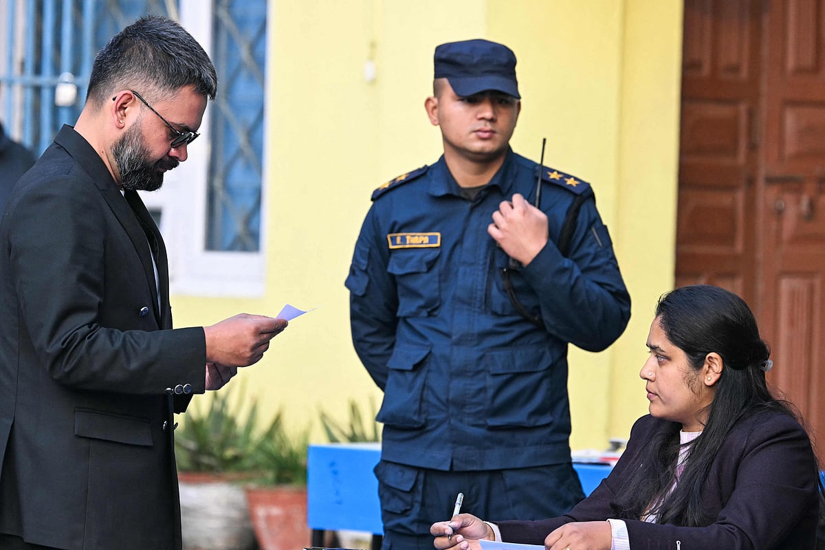 Rastriya Swatantra Party (RSP) election candidate Balendra Shah (L) waits to vote at a polling station during Nepal's parliamentary election in Kathmandu on 5 March, 2026.