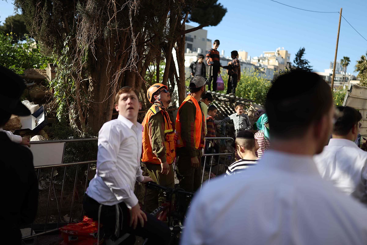 Israeli first responders gather at the site of an Iranian strike in Bnei-Brak, just east of Tel Aviv on 8 March 2026. Six people were wounded, some by shrapnel, at blast sites in central Israel on March 8, according to first responders, after the military said it had detected a new wave of Iranian missiles.