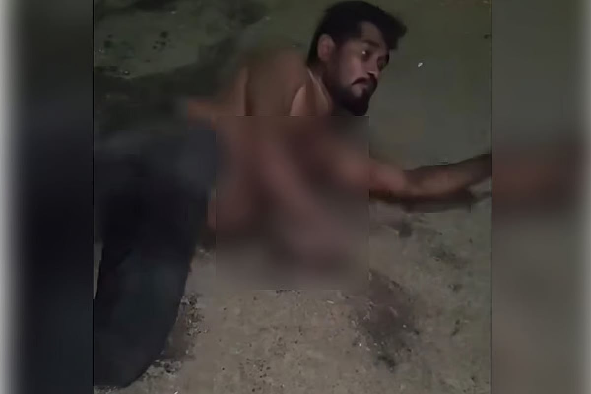 A man is seen writhing on ground