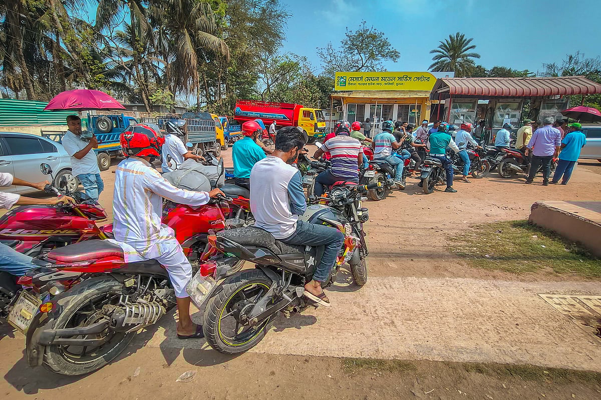 Early in the morning, motorcyclists queue at a petrol pump to refuel. Power House More, Khulna, 9 March 2026.