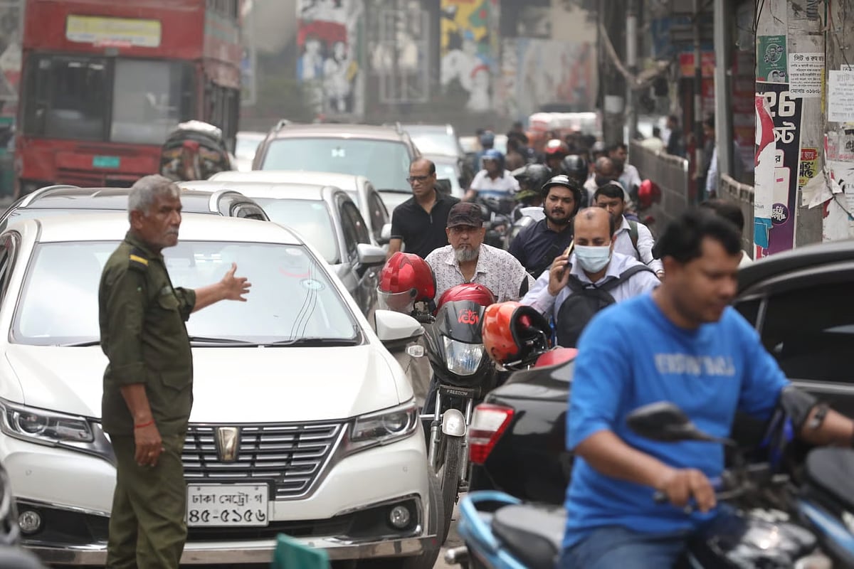 Motorcycle and private vehicle drivers queue in a long line to buy fuel at a filling station in the Paribagh area of Dhaka on 9 March 2026.