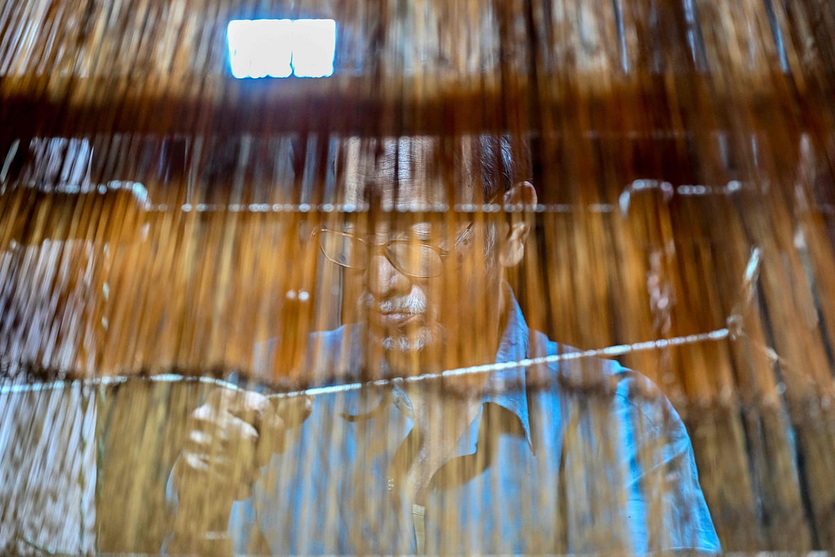 A Bangladeshi craftsman weaves fabric on a traditional handloom inside a workshop in Tangail on 2 March, 2026.