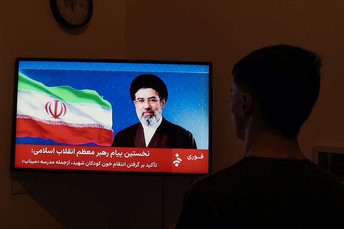  A man watches a televised statement by Iran's new supreme leader Mojtaba Khamenei on 12 March 2026. Iran's new supreme leader ordered the vital Strait of Hormuz oil shipping lane to remain closed on 12 March, while US President Donald Trump said stopping the Islamic republic's "evil empire" was more important than crude prices. Ayatollah Mojtaba Khamenei, who was reportedly injured in an air strike, has yet to appear publicly since his nomination as supreme leader, and his defiant message was read by a newscaster on state television.