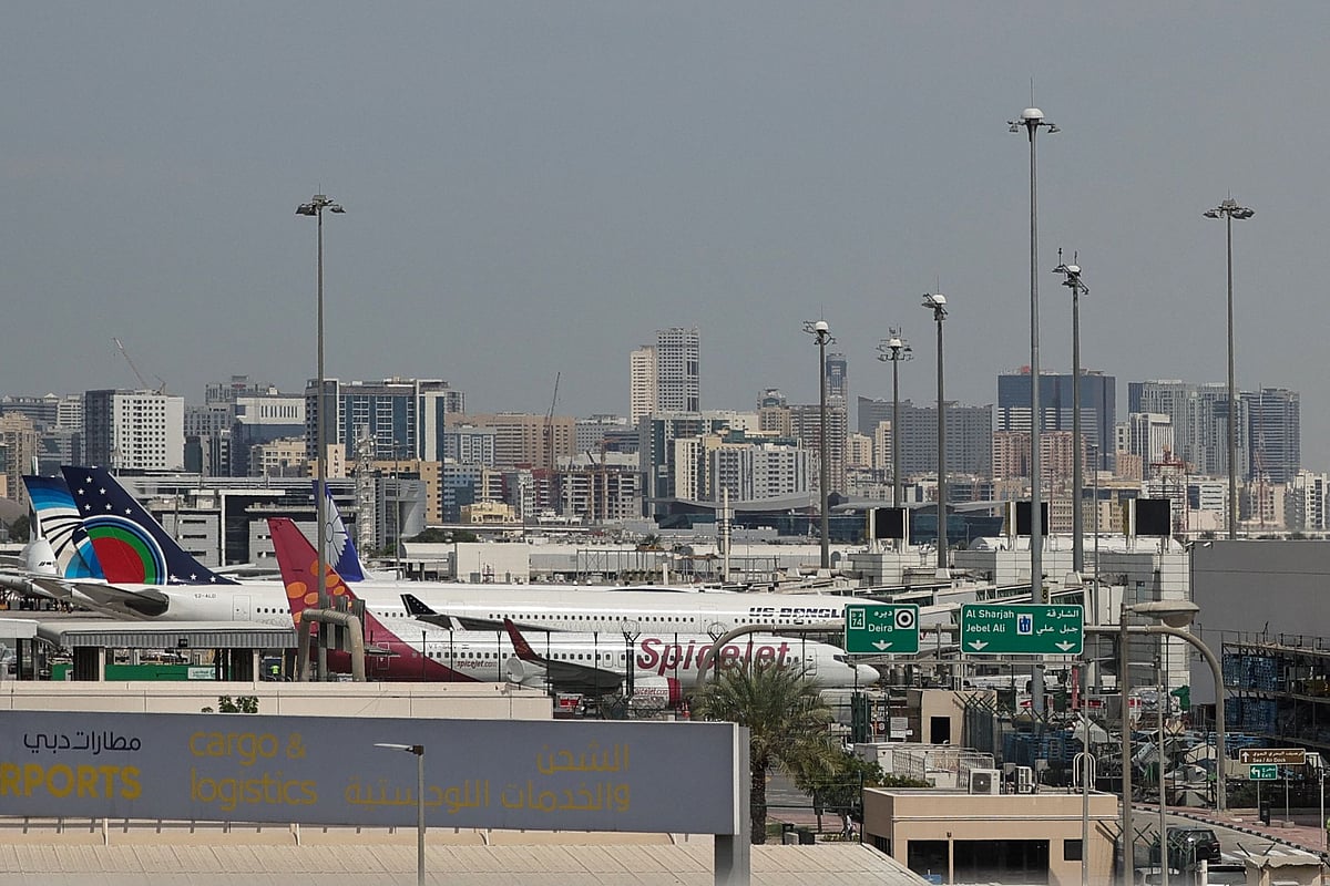 Passenger planes are parked at Dubai International Airport in Dubai on March 11, 2026. Drones fell near Dubai airport, injuring four people, while ships were hit in or near the Strait of Hormuz on March 11 as Iran kept up its campaign disrupting oil markets and air and maritime traffic.