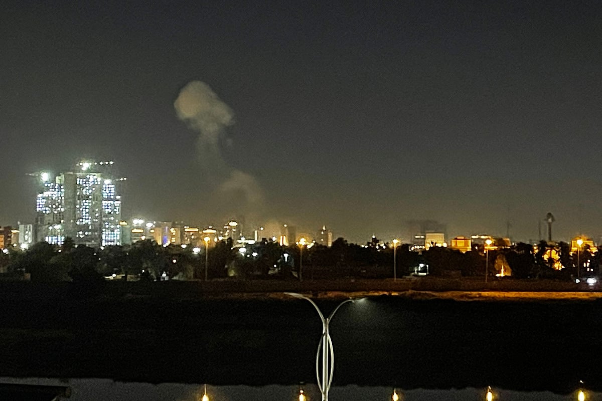 A plume of smoke rises over the Iraqi capital Baghdad on 16 March, 2026. A loud explosion was heard in Baghdad late on March 16, AFP journalists said, with smoke seen near the city's heavily fortified Green Zone.