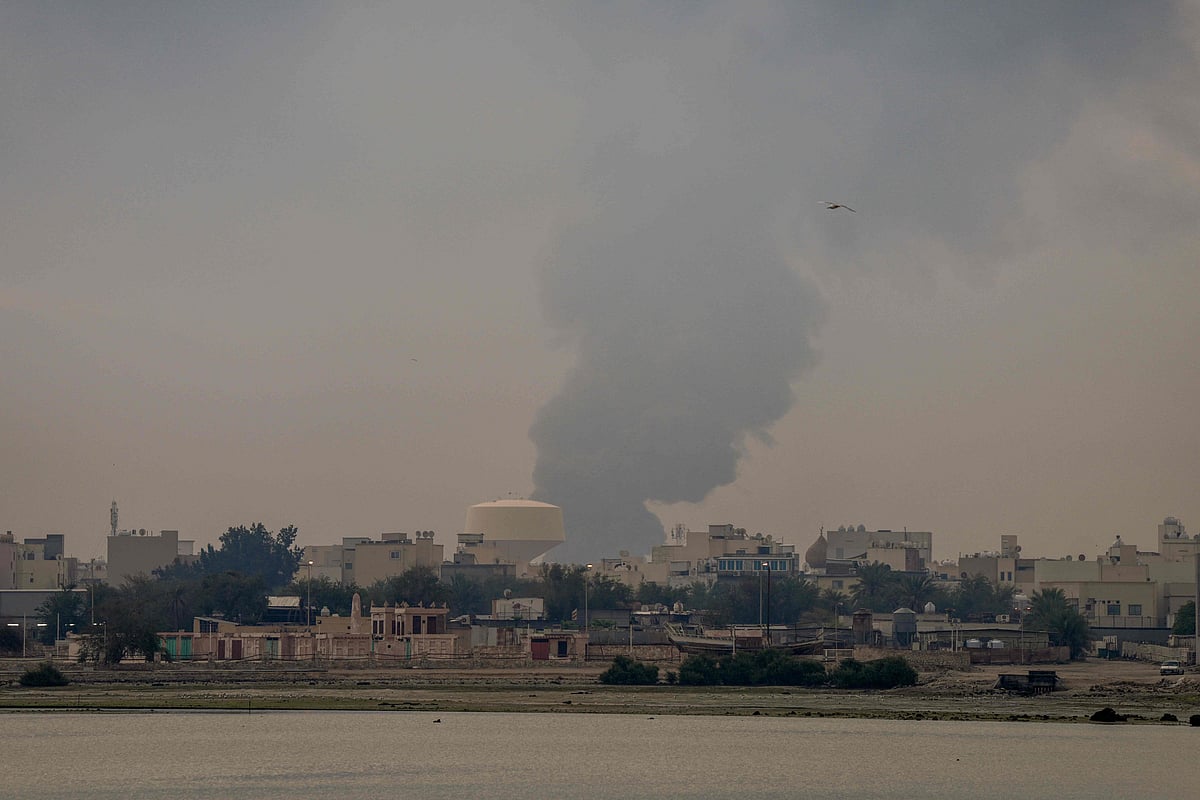 A plume of smoke rises after a reported Iranian strike on fuel tanks in Muharraq on 12 March 2026