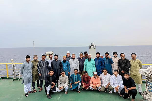 Bangladeshi sailors of the ship "Joyjatra," stranded in the Persian Gulf, take a photo after performing Eid prayers today, Friday.