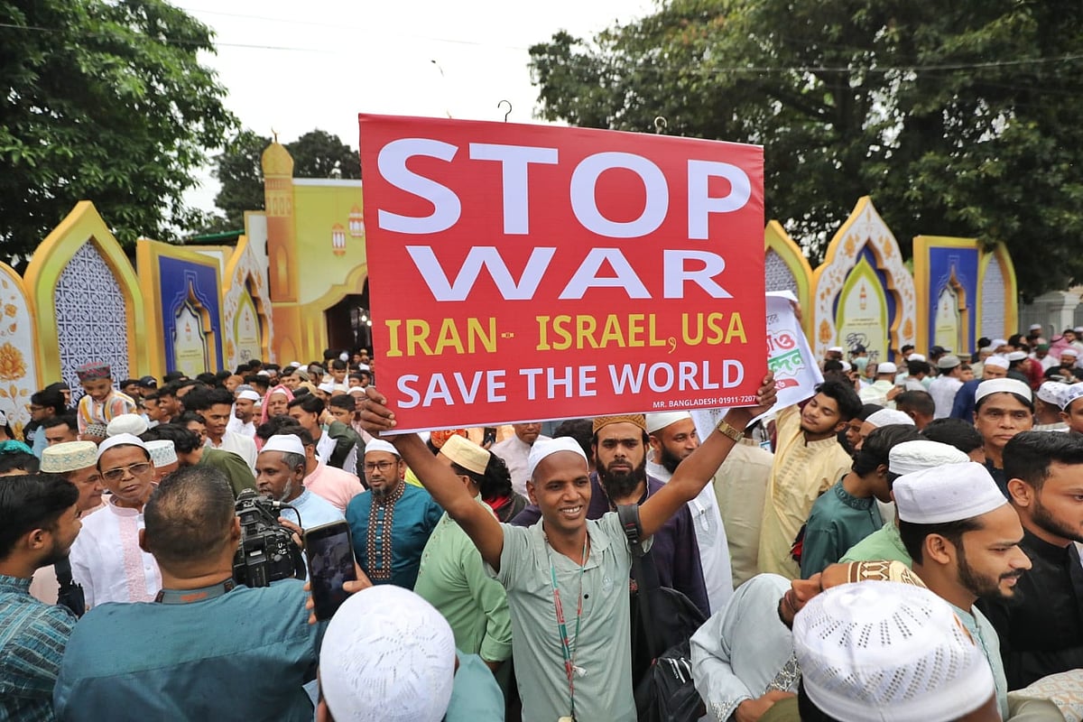 A devotee, who comes to attend the Eid-ul-Fitr prayer, shows a placard urging ending the war in the Middle East. The photo is taken at National Eidgah, Dhaka on 21 March 2026 