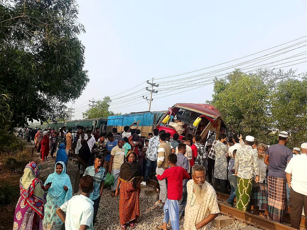 People gather on the site of the accident. The bus was dragged for nearly half a kilometre along the railway tracks on 22 March 2026