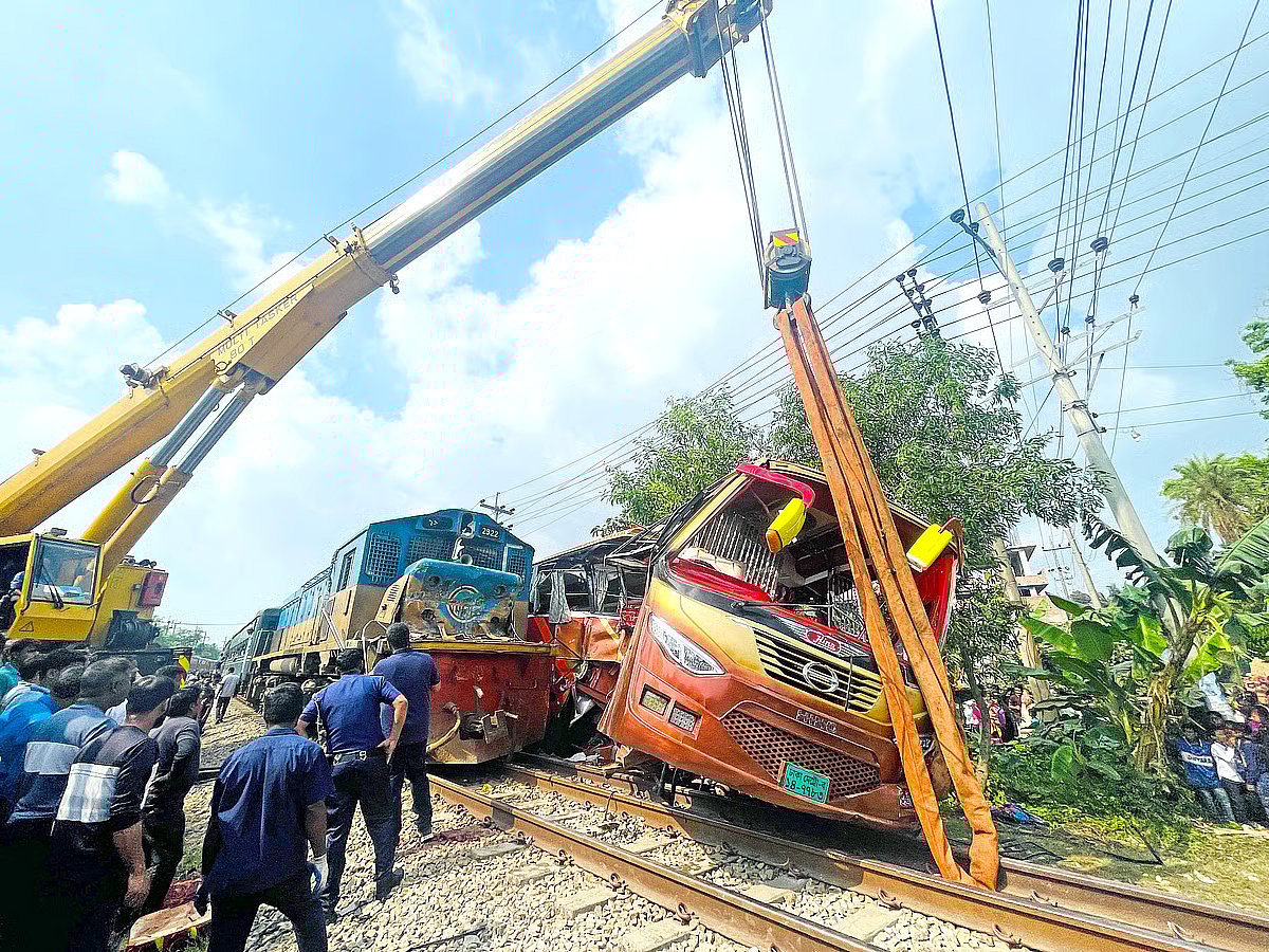 A train approached as the bus was crossing the railway line, resulting in a collision. The train then pushed the bus a considerable distance, leaving it severely mangled. The incident occurred in the Paduar Bazar area of Cumilla Sadar South upazila on 22 March 2026
