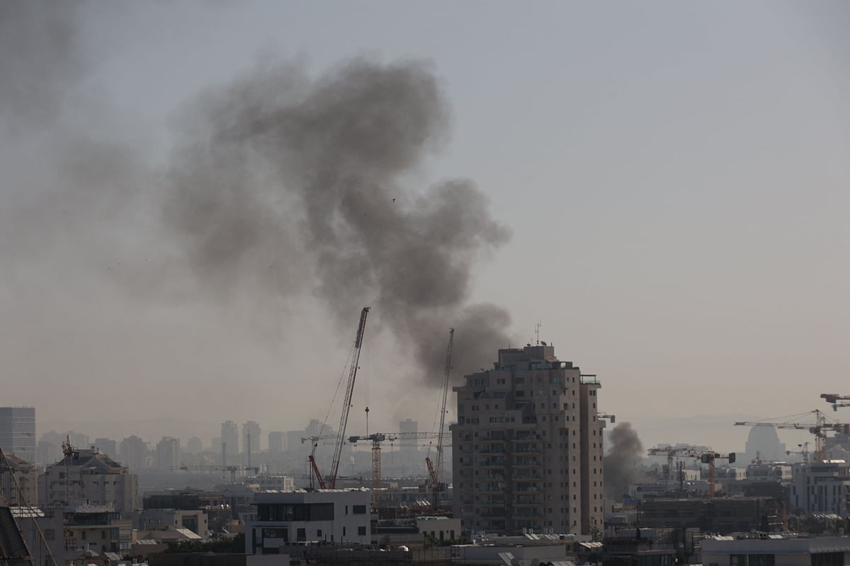 Smoke rises from an Iranian missile strike in Tel Aviv on March 23, 2026. Iran fired a fresh broadside of missiles at Israel March 24, causing damage and injuries in Tel Aviv, as uncertainty swirled over possible talks to end the three-week Middle East war