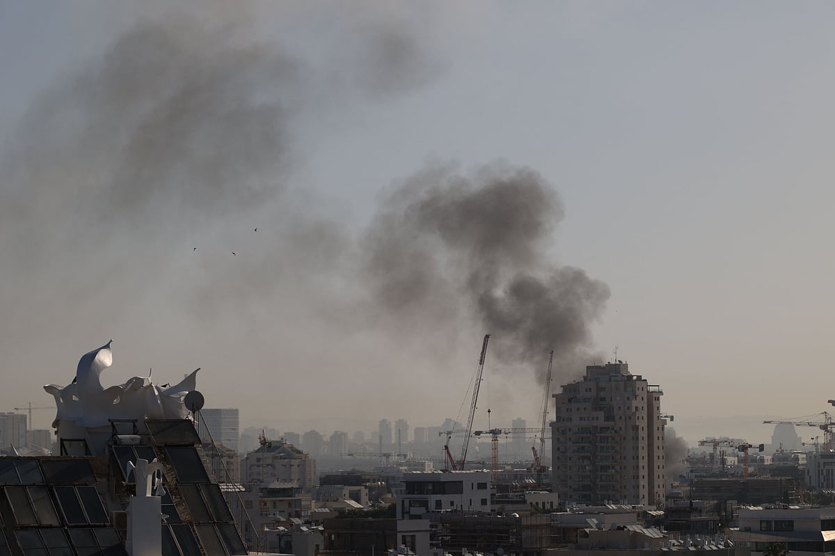 Smoke rises from an Iranian missile strike in Tel Aviv on March 23, 2026. Iran fired a fresh broadside of missiles at Israel March 24, causing damage and injuries in Tel Aviv, as uncertainty swirled over possible talks to end the three-week Middle East war.