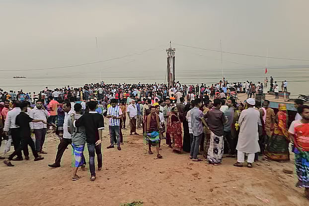 Crowd gathers upon hearing of a passenger bus falling into the Padma River on Wednesday afternoon at Rajbari's Daulatdia ferry terminal.