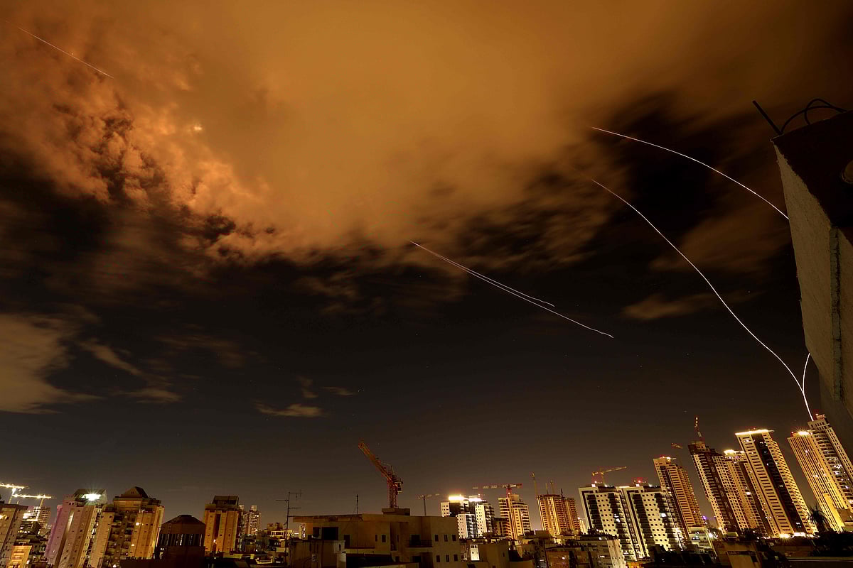 Rocket trails are seen in the sky above the Israeli coastal city of Netanya amid a fresh barrage of Iranian missile attacks on 25 March, 2026.