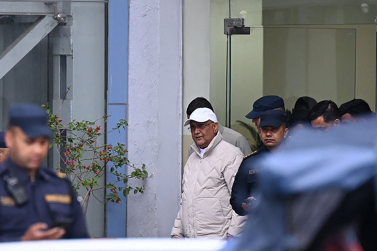 Nepal's former prime minister KP Sharma Oli is escorted by police as he is brought to the hospital following his arrest in Kathmandu on 28 Mach, 2026.
