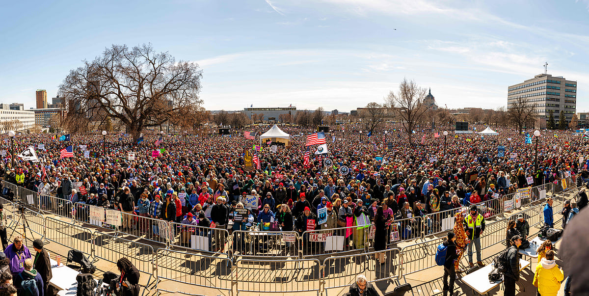 This panoramic image shows a large crowd gathered outside the Minnesota State Capitol during the "No Kings" national day of protest in Saint Paul, Minnesota, on March 28, 2026. Huge crowds of protesters rallied across the United States on March 28 against President Donald Trump, venting their fury over what they see as his authoritarian style of governing, his hardline immigration policies and the war with Iran
