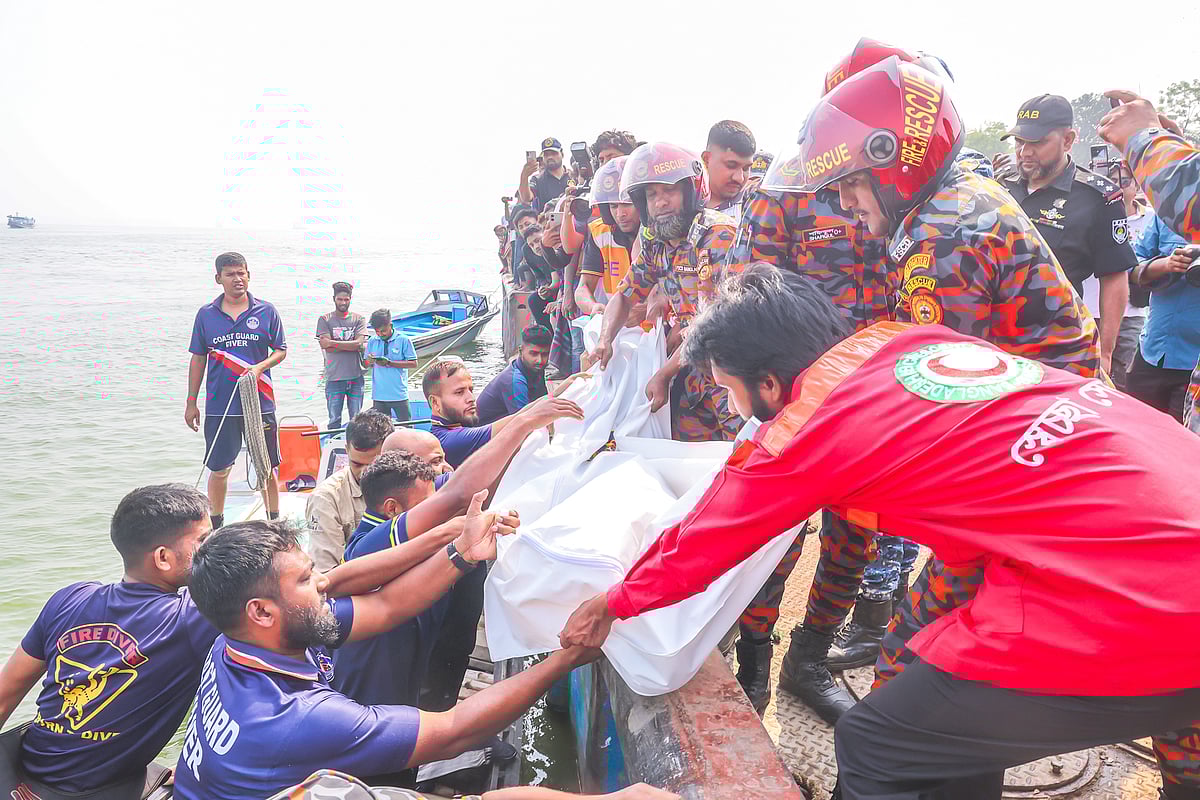 The rescuers are recovering body of a passenger of the sunken bus in the Padma river at Daulatdia Ferry Terminal.