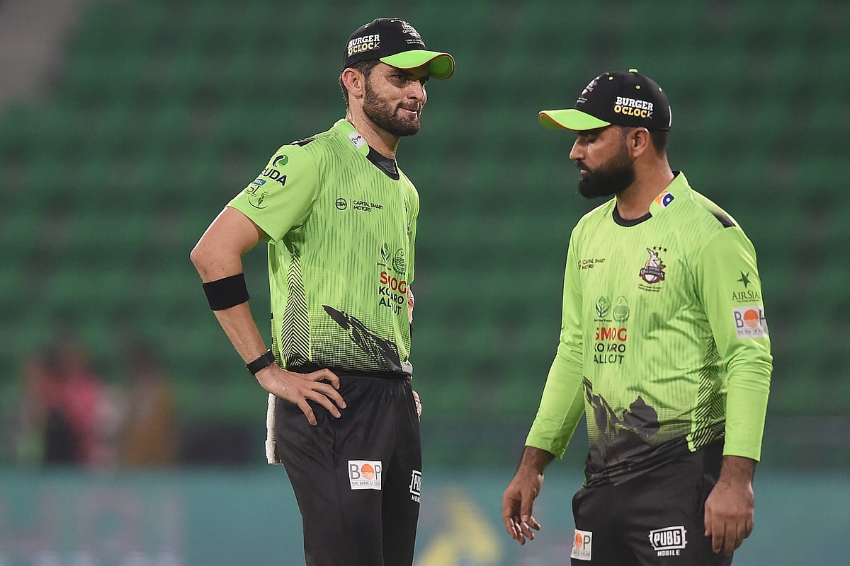 Lahore Qalandars' captain Shaheen Shah Afridi (L) speaks with teammate Fakhar Zaman (R) during the Pakistan Super League (PSL) T20 match between Karachi Kings and Lahore Qalandars at the Gaddafi Cricket Stadium in Lahore on March 29, 2026. Lahore Qalandars' Fakhar Zaman could face a ban after being charged with a ball-tampering offence in his side's defeat to Karachi Kings in the T20 Pakistan Super League