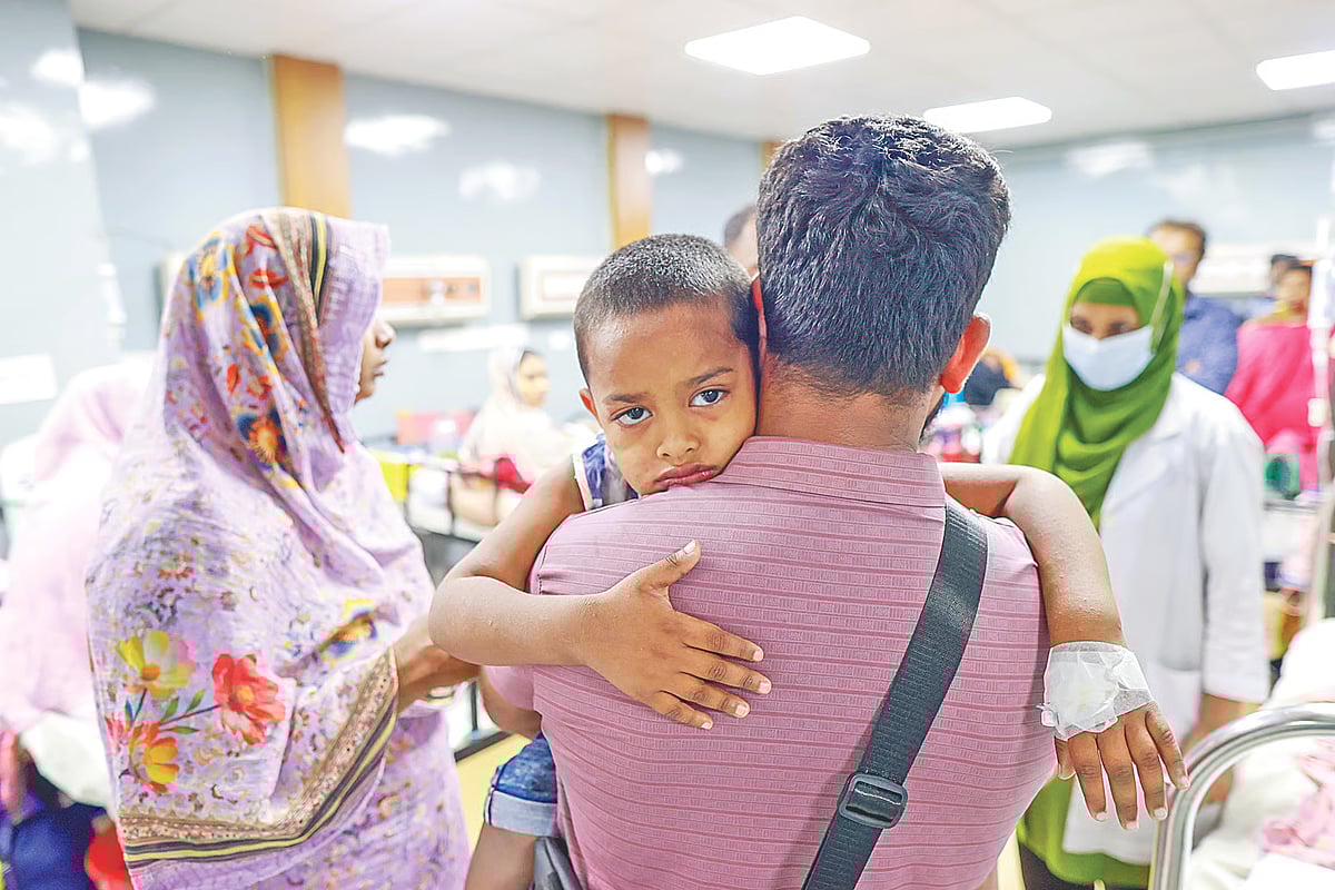 A man holds his child suffering from measles in his arms to comfort him after he was admitted to Dhaka Children’s Hospital on 31 March 2026.