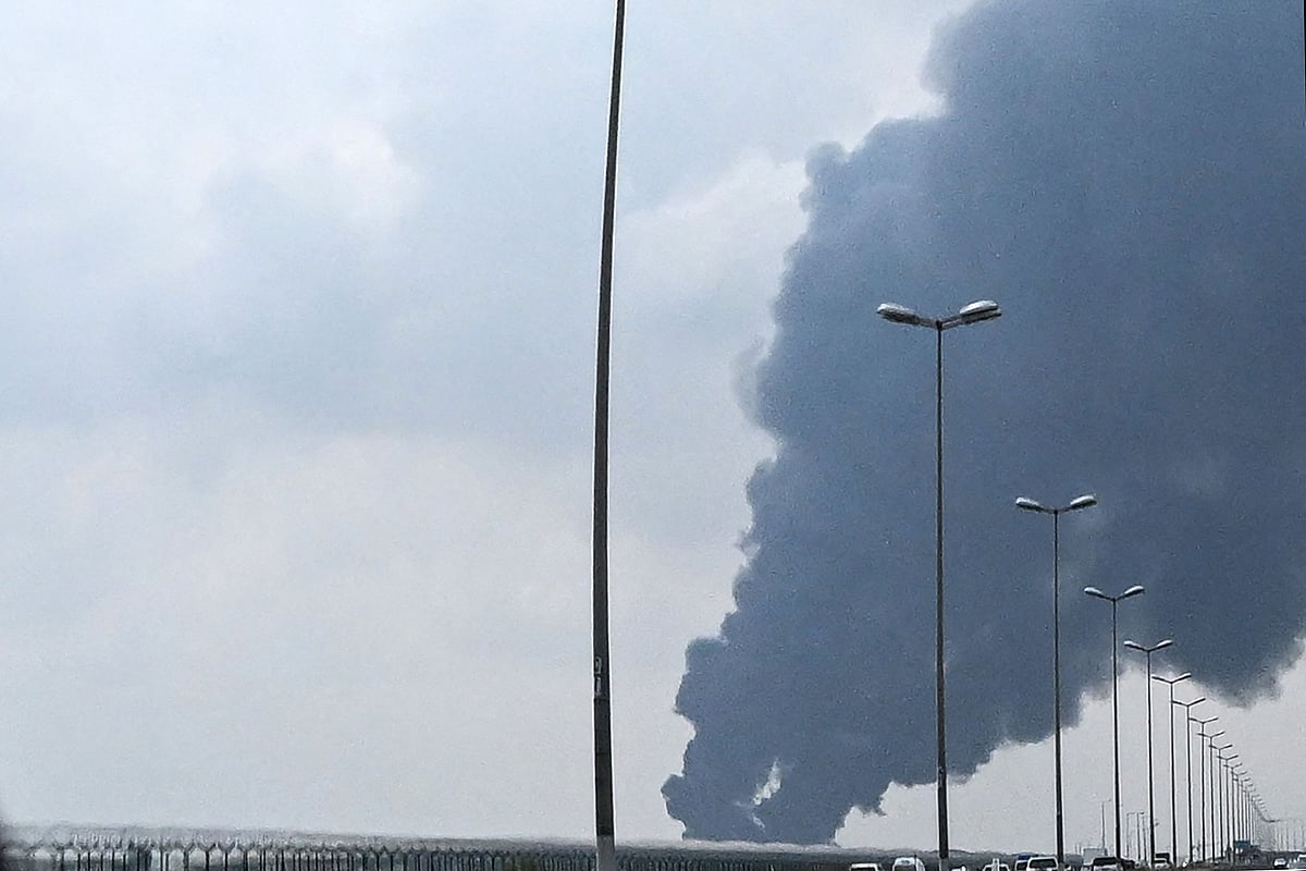 Smoke rises from the area of the Kuwait International Airport after a reported drone strike