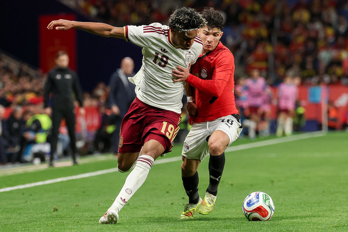 Spain's forward #19 Lamine Yamal (L) vies for the ball with Egypt's forward #18 Islam Issa during the international friendly football match between Spain and Egypt at RCDE Stadium in Cornella de Llobregat, near Barcelona, on March 31, 2026.